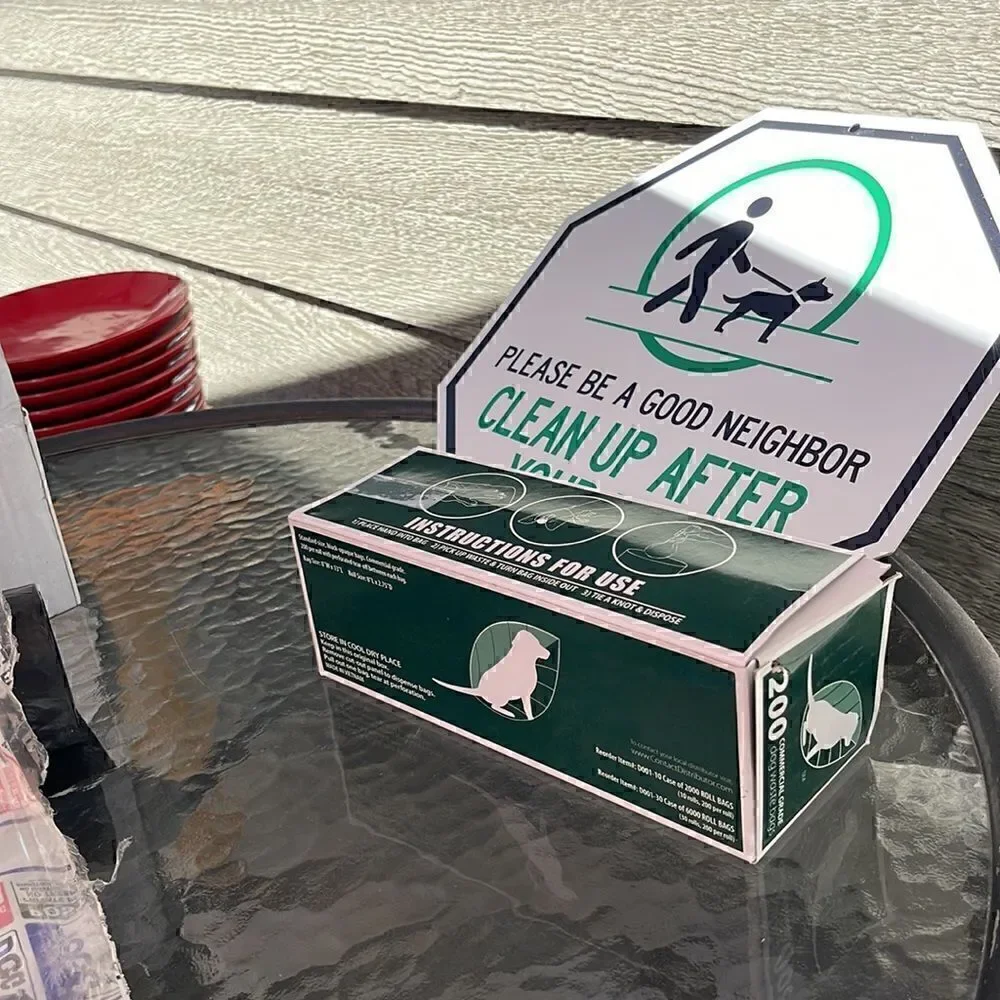 Dog waste bag and sign. Please be a good neighbor, clean up after your dog. New